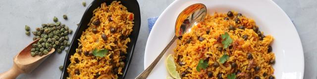Indian cuisine - Chickpeas Biryani, chole Pulao. Garnished with fried onion, chopped coriander, and lemon wedges. Kala chana biryani. Along with copy space.
